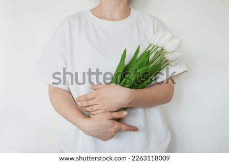 Similar – Image, Stock Photo artificial white tulips and green leaves in a black vase on the table in home interior.