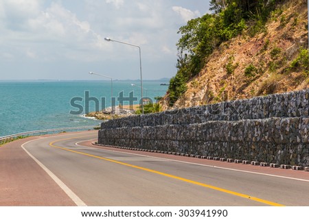 curve road with sea view with blue sky in Thailand