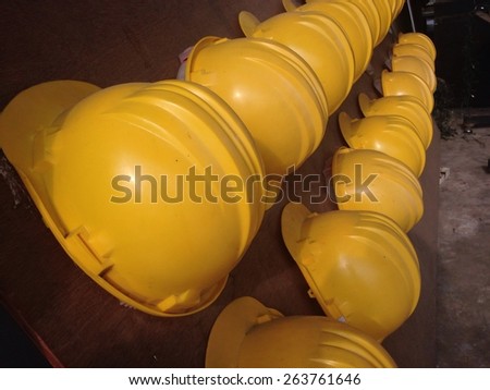 Yellow hard hats on wood board