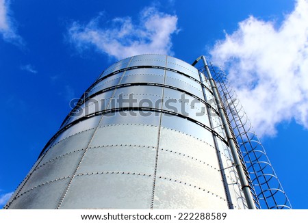 Towering grain silo under blue skies. Storage of grain.