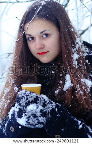 Beautiful Happy Smiling Winter Woman with cup Outdoor. Laughing Girl Outdoors with Hot Drink