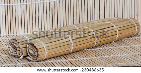 Two rolled bamboo mats for kitchen table