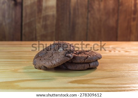 soft dark chocolate brownie cookies on wooden table.