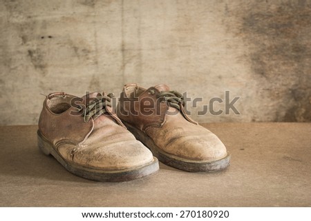 still life with brown leather shoes old