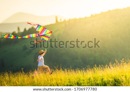 Image, Stock Photo Boy with striped kite on the beach in ICM technique.