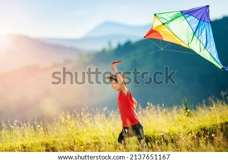 Similar – Image, Stock Photo Boy with striped kite on the beach in ICM technique.