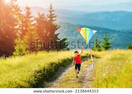 Similar – Image, Stock Photo Boy with striped kite on the beach in ICM technique.