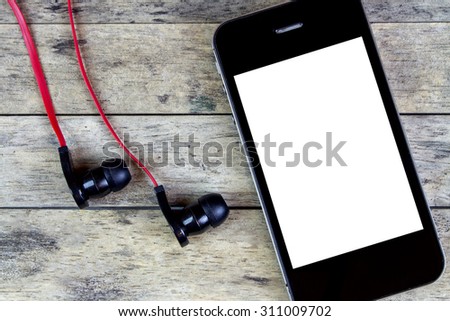 earphones and smart phone on a wooden table