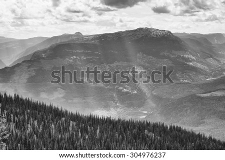 Sun rays coming through clouds on mountain