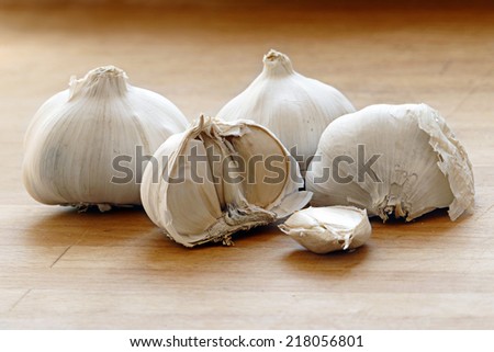 Garlic bulbs and cloves on wooden board, natural medicine, eat healthy food