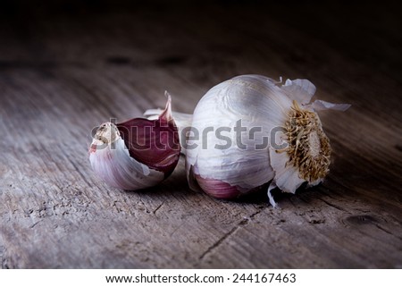organic garlic with a clove on a rustic wooden background