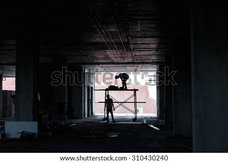 Silhouette of construction worker on construction site.