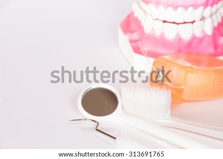 Dental tools set and teeth model on white background.Medical concept.