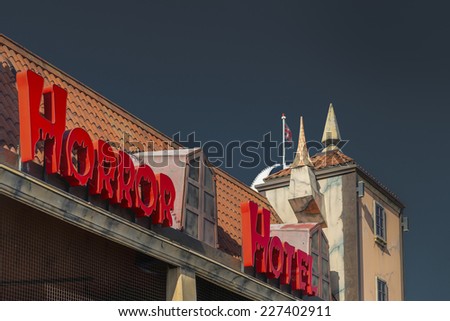 BRIGHTON, UK - OCTOBER 26: The sign and roof of the Horror Hotel ghost train ride on Brighton's Palace Pier shown on October 26, 2014 in Brighton, UK