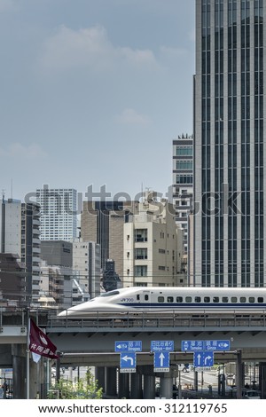 TOKYO, JAPAN - AUGUST 7:  A Tokaido shinkansen bullet train speeds across a bridge over a city street in Tokyo shown on August 7, 2015 in Tokyo, Japan