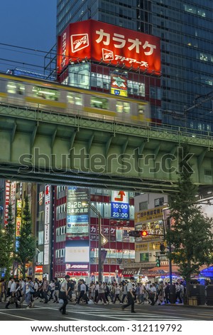 TOKYO, JAPAN - AUGUST Evening rush hour traffic in Akihabara with the bright neon advertisements in the background shown on August 7, 2015 in Tokyo, Japan