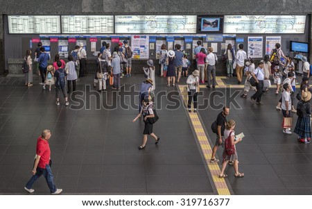 KYOTO, JAPAN - AUGUST 12: Passengers buy tickets from self service ticket machines at Kyoto station shown on August 12, 2015 in Kyoto, Japan