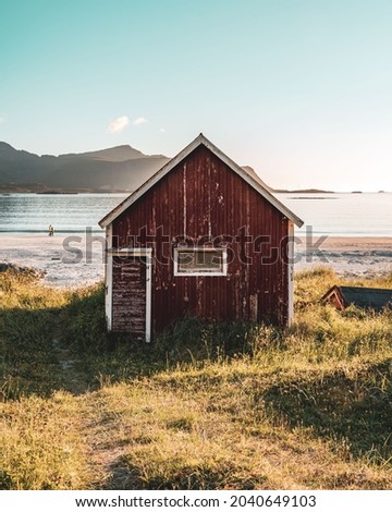 Norway red hut fishing village. Red fishing hut landscape Norway. Norwegian red fishing hut.