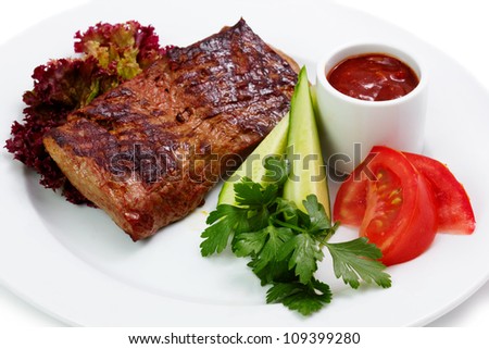 Roasted pork steak with vehetables isolated on white background