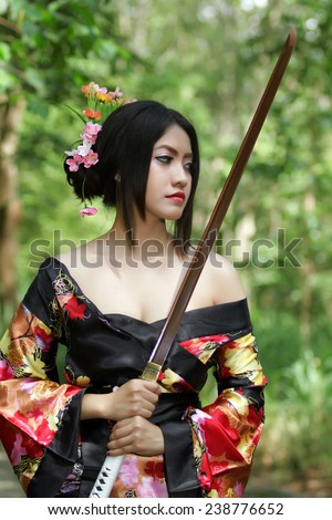 portrait Asia Beautiful Japanese kimono woman and Japanese geisha woman with Japanese sword and Woman with japan sword katana in hands