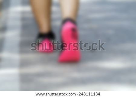 blurry Athlete runner feet running on road closeup on shoe. woman fitness  jog workout on road for background