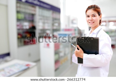 Smiling medical doctor woman asia with stethoscope and clipboard checking medicine cabinet .