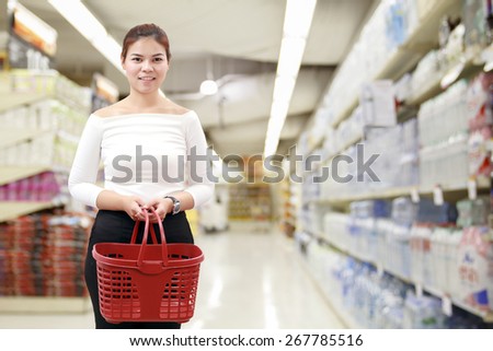 happiness, consumerism, sale and people concept - smiling young woman Asian with shopping basket and buy vegetable/fruit at supermarket/mall