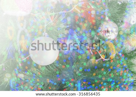 Christmas ornaments on the Christmas tree and Christmas background of de-focused lights on soft focus.