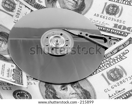 A hard drive platter surrounded by money. Signifying the high cost of storage and bandwidth