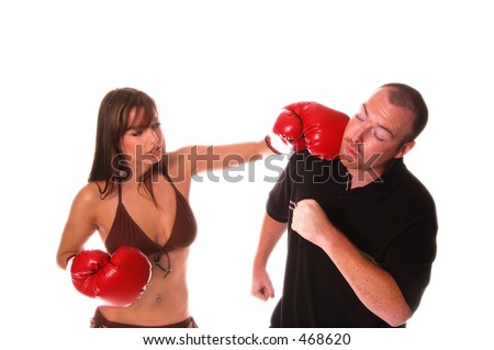 Sexy redheaded bikini  model in boxing gloves knocks out a big guy  isolated over white