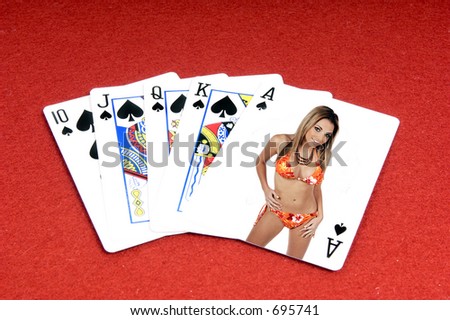 One of the highest hands in poker a Spades Royal Flush on a red felt gaming table