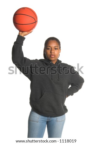 Sexy inner city African American woman in jeans and a sweat shirt playing basketball