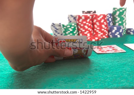 Texas Hold \'Um poker player peels back her cards to reveal a suited King and Jack of hearts that could potentially lead to a  hearts Royal Flush Generic no label card backs from China