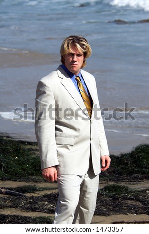 Business man in a suit on the beach