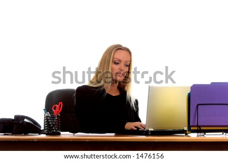 Strong and beautiful corporate executive at her desk conducting business on her laptop computer