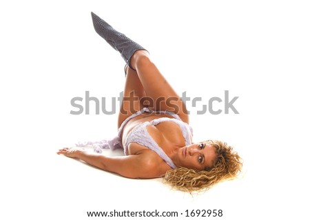 A beautiful Latina woman in a purple faux fur thong cut bikini and knee high boots