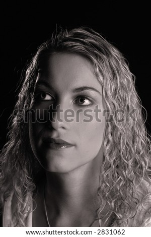 Black and white head shot of a beautiful blond woman with curly blond hair