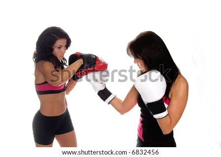 Two beautiful female boxers training on focus mitts