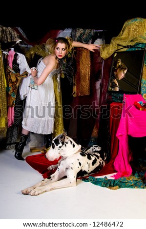 Beautiful young woman in her closet playing dress up with her Great Dane and her reflection showing in the mirror