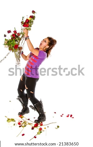 Angry young brunette woman with a vase of flowers shows how much love hurts