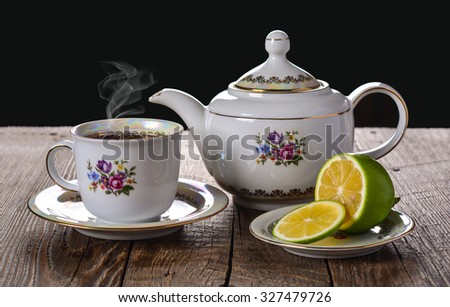 Teapot and teacup, tea drinking with lemon