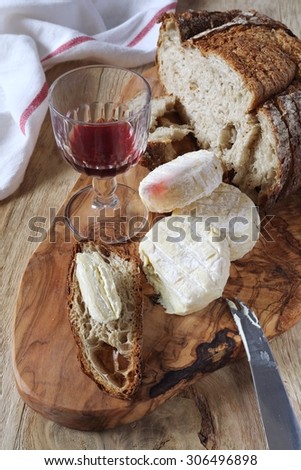 French Goat cheese, french country  bread and glass of red wine