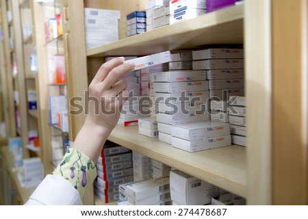 Pharmacist take medicine from shelf