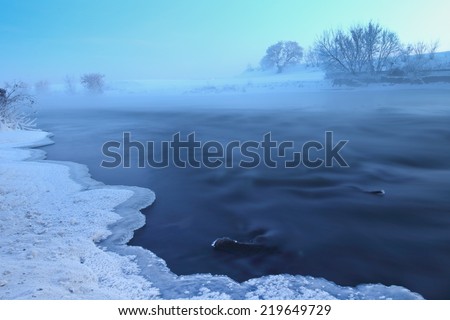 Winter landscape with cold winter river sunrise.