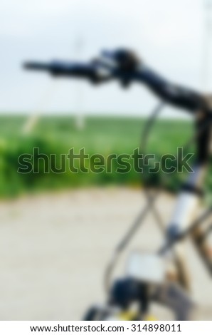 Blurred defocused abstract background with bicycle on the village road