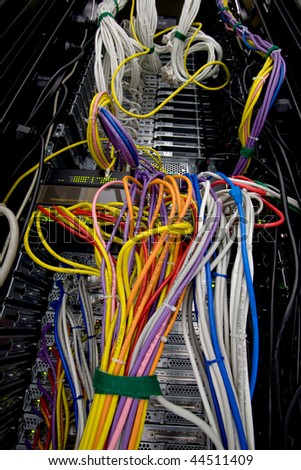 Messy servers stack with cabling in a data center cabinet