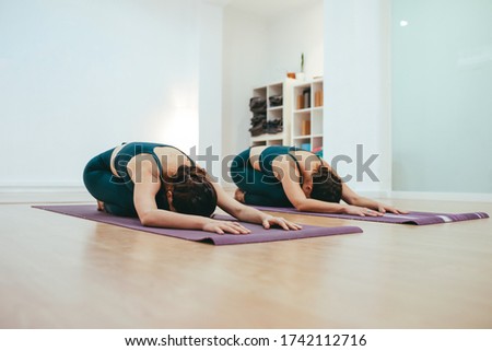 Similar – Image, Stock Photo Yoga girls doing Anahatasana pose. Cenital Plane