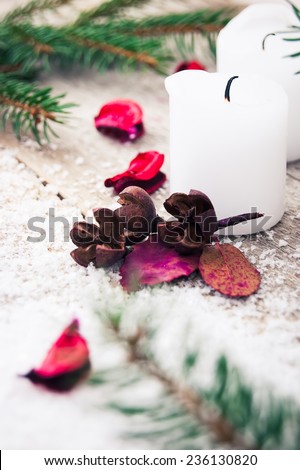 candle with dried flowers on a Christmas background