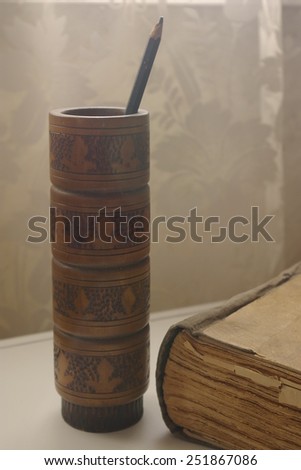 Still life with pencil and book