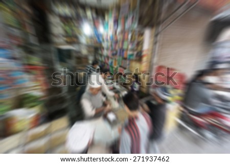 Blurry image of people at street market in India in sunny day, blur background with zooming effect in Chandni Chowk, India